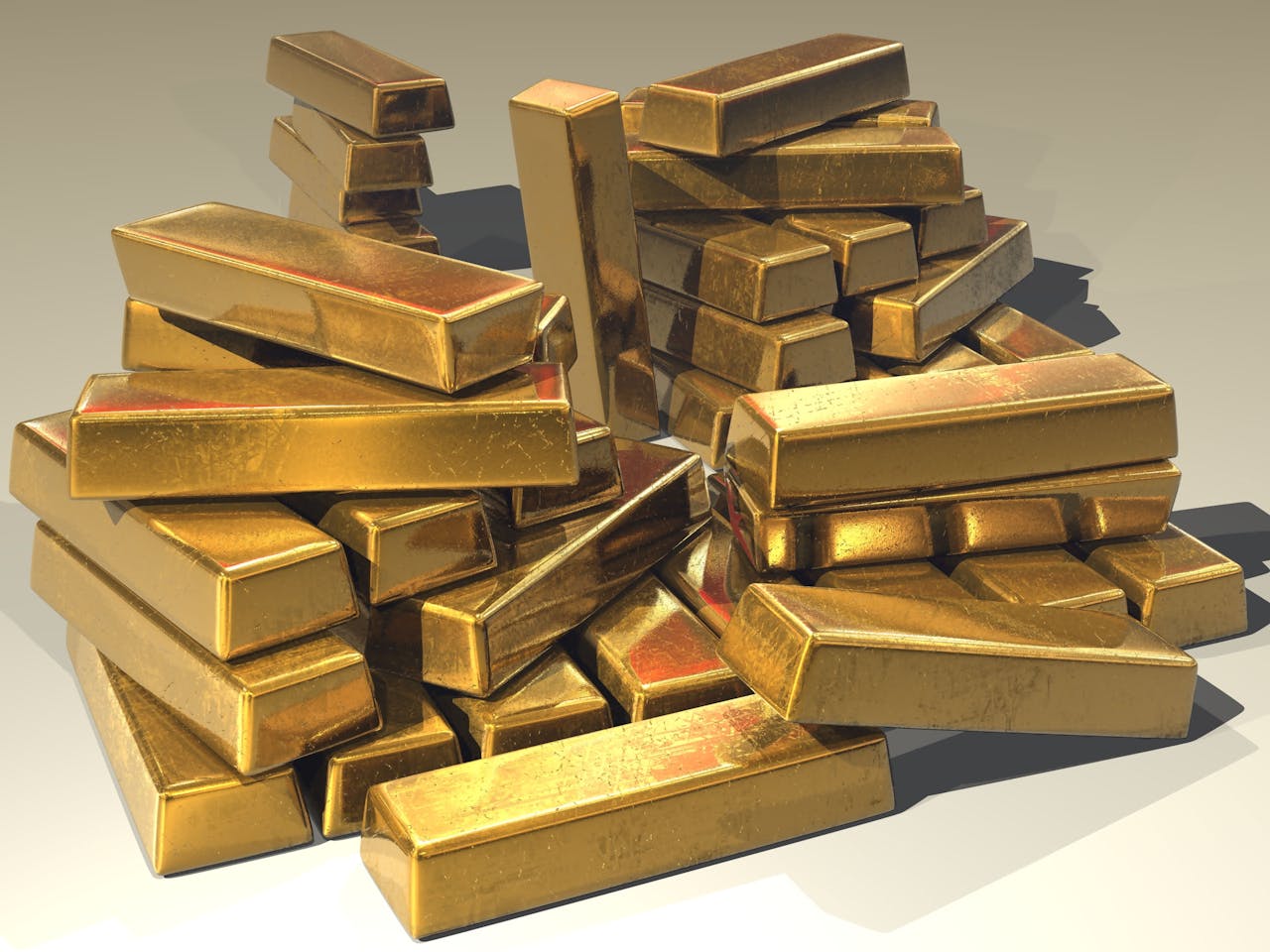 creative-01 A pile of lustrous gold bars symbolizing wealth and prosperity.