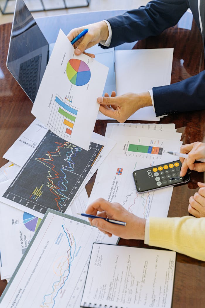 mobile-02 Business professionals analyzing financial charts and graphs during a meeting.
