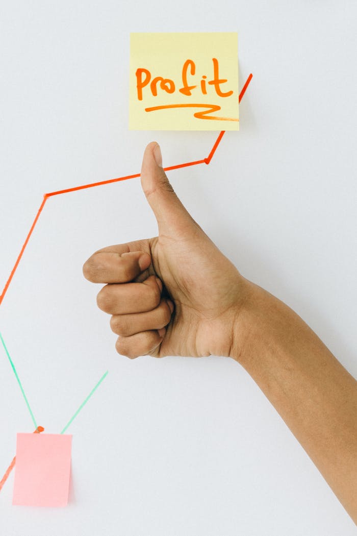 digital-01 A hand giving a thumbs up in front of a profit growth chart, highlighting success.
