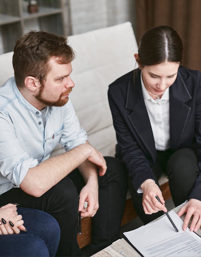 creative Business professionals in a meeting reviewing significant documents in an office setting.